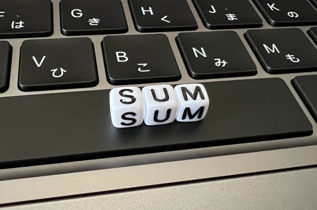 パソコンの上に置かれたSUMのブロック