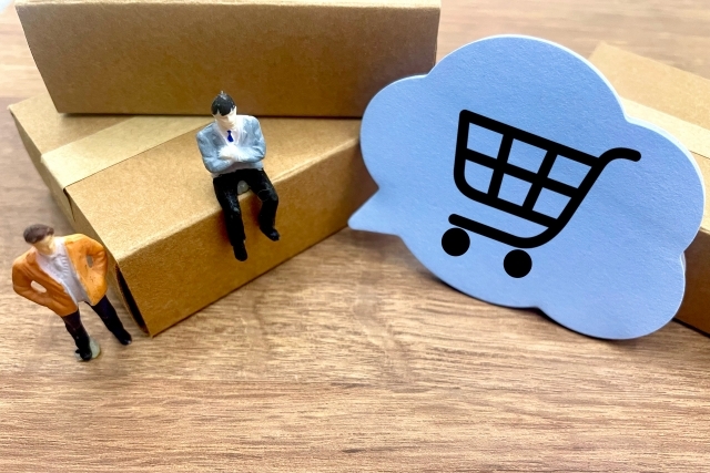 人の人形とショッピングカートのアイコン