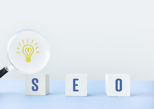 電球マークが浮かぶ虫眼鏡